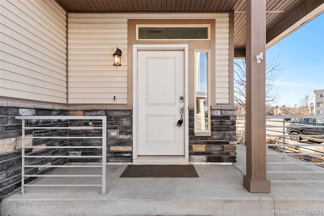 doorway to property featuring stone siding