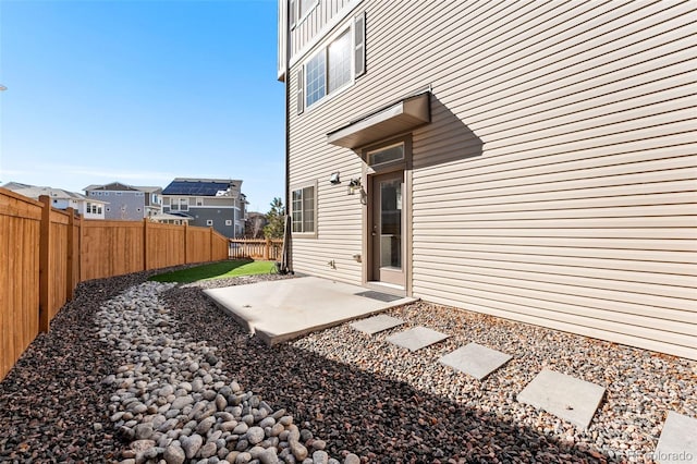 exterior space with a residential view, a patio area, and a fenced backyard