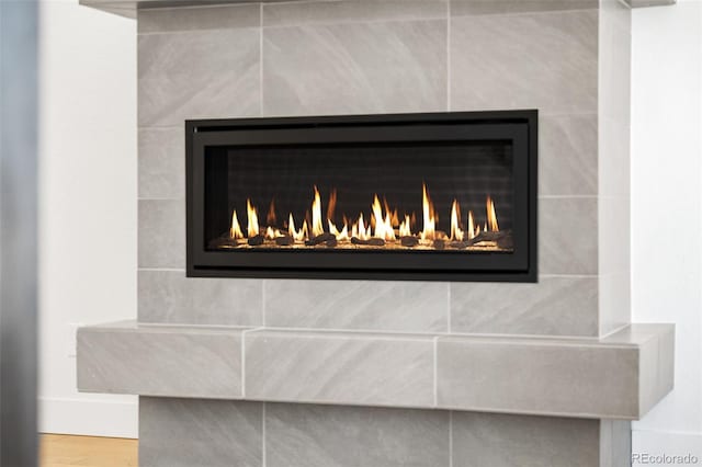 interior details with a tile fireplace