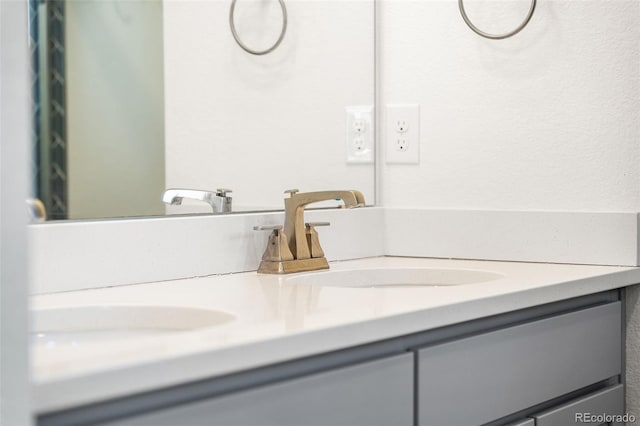 bathroom with a sink and double vanity