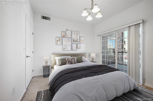 bedroom with access to exterior, a chandelier, and carpet flooring