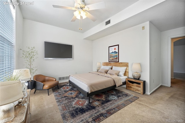 bedroom featuring light colored carpet and ceiling fan