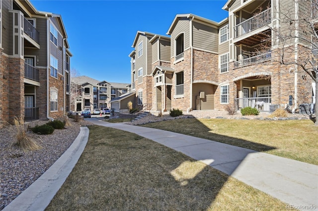 view of home's community featuring a lawn