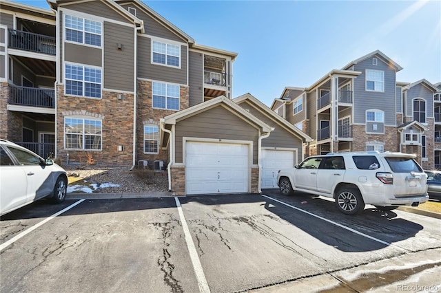 multi unit property featuring central AC and a garage