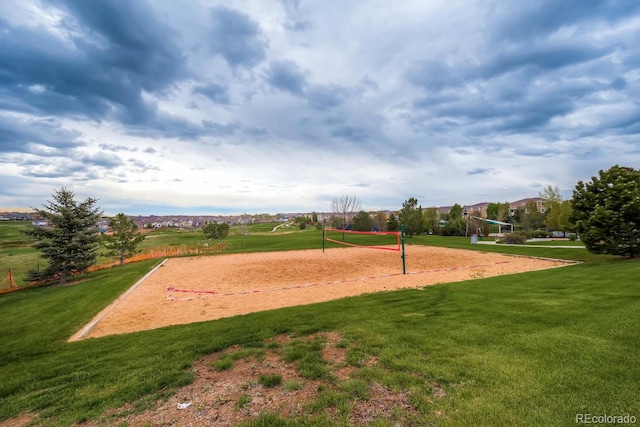 view of property's community featuring a lawn and volleyball court