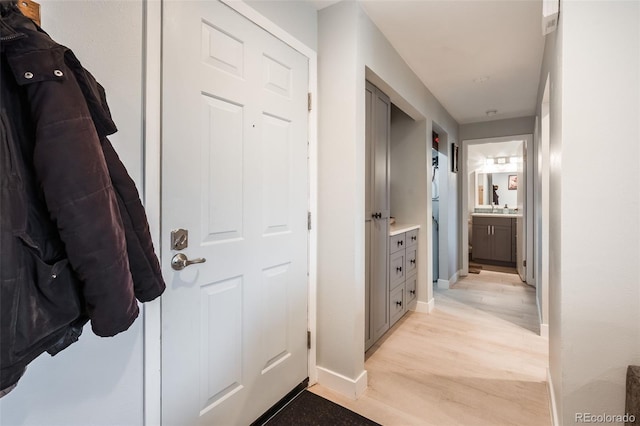 hallway featuring light hardwood / wood-style flooring and sink