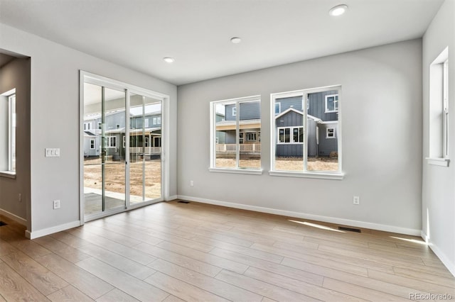 unfurnished room featuring recessed lighting, baseboards, and wood finished floors