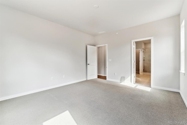 unfurnished bedroom with light carpet and baseboards