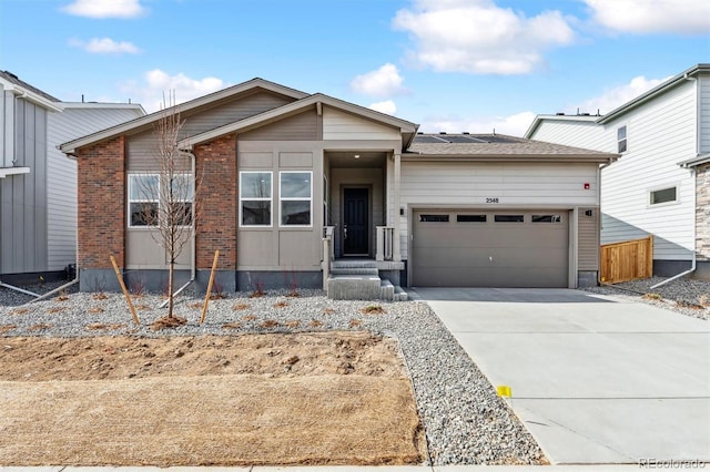 view of front of property with brick siding, concrete driveway, and an attached garage