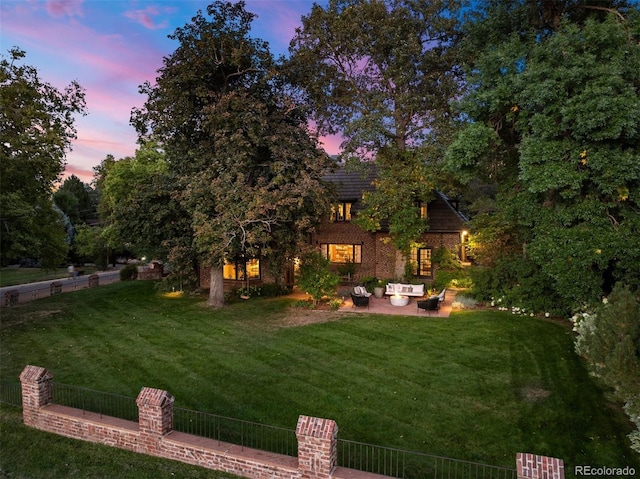 view of yard featuring a patio, outdoor lounge area, and fence