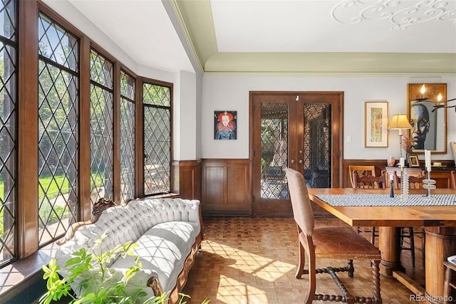 dining room featuring a wainscoted wall and plenty of natural light