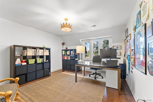 home office with lofted ceiling, visible vents, dark wood finished floors, and baseboards