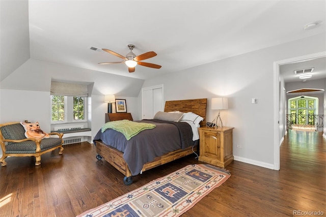 bedroom featuring visible vents, dark wood finished floors, and multiple windows