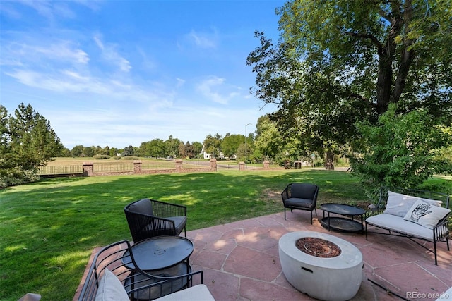 view of patio featuring an outdoor fire pit and fence