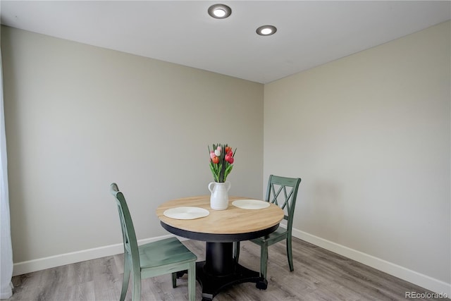 dining space with baseboards, recessed lighting, and wood finished floors