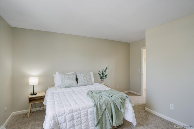 bedroom with baseboards and carpet