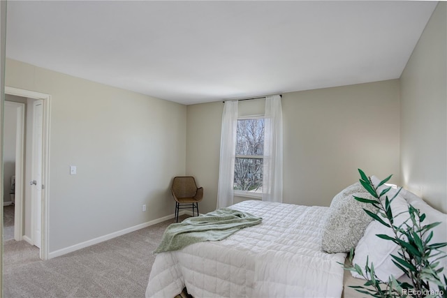 carpeted bedroom featuring baseboards