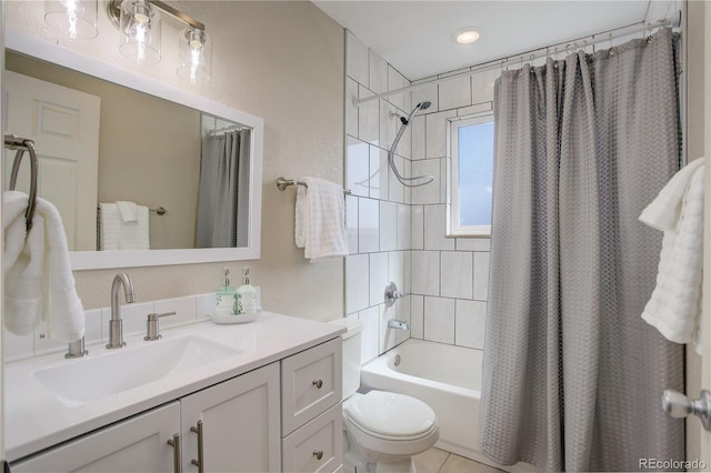 full bath featuring shower / bath combo, vanity, toilet, and a textured wall