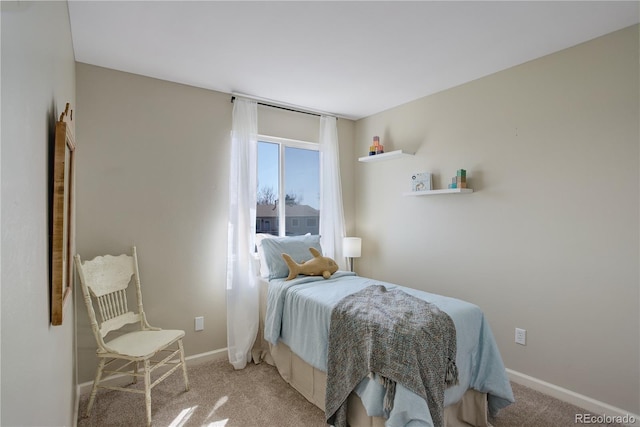 bedroom featuring baseboards and light carpet