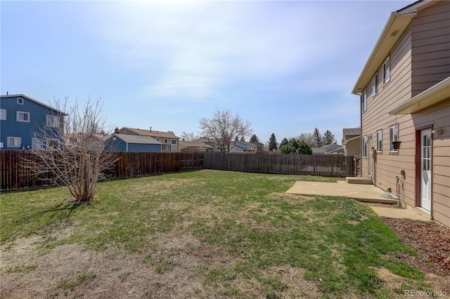 view of yard featuring a patio, a residential view, and a fenced backyard