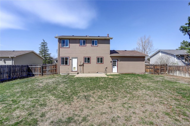 back of property with a yard, a fenced backyard, and a patio area
