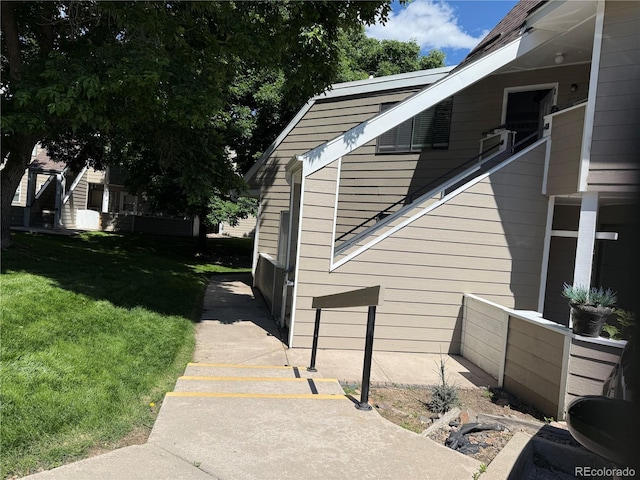12478 W Nevada Pl Unit 207, Lakewood, CO 80228 - view of home's exterior featuring a lawn