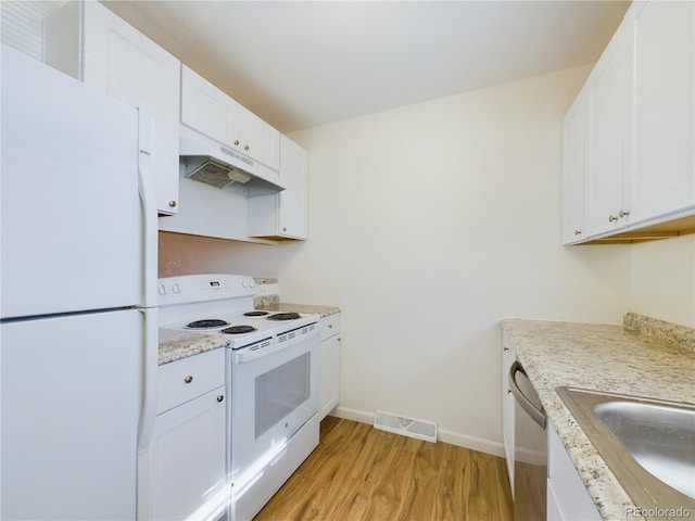 kitchen featuring sink, white appliances, light stone counters, white cabinets, and light wood-type flooring