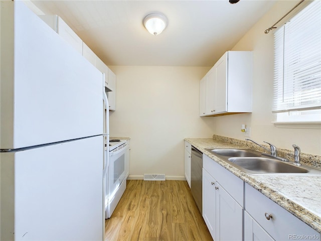 kitchen with white cabinetry, sink, white appliances, and light hardwood / wood-style floors