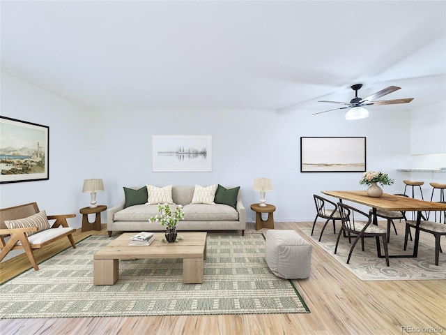 living room with ceiling fan and light hardwood / wood-style flooring