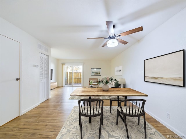 dining space with wood-type flooring, lofted ceiling, and ceiling fan