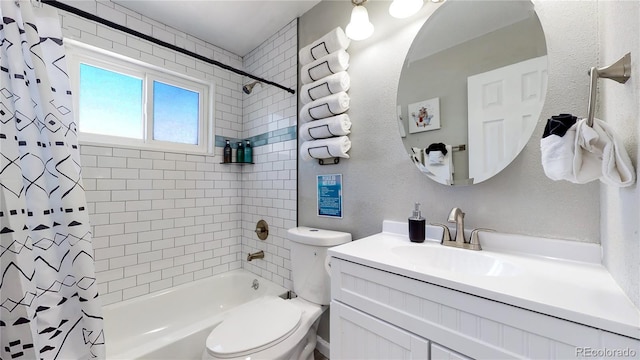 full bathroom with vanity, shower / bath combo with shower curtain, and toilet