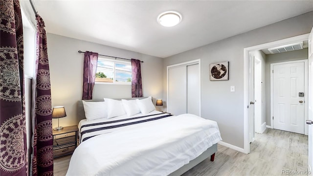 bedroom with a closet and light wood-type flooring