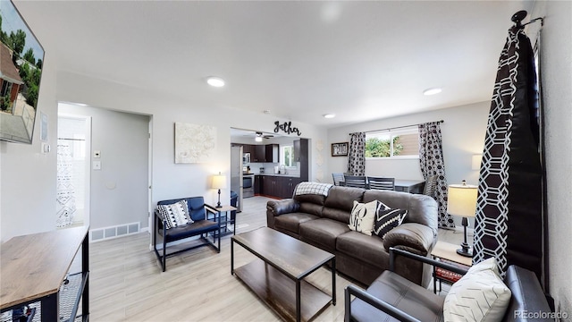 7020 Avrum Dr, Denver, CO 80221 - living room with light wood-type flooring, recessed lighting, a ceiling fan, and baseboards