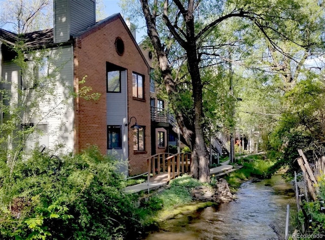 1633 18th St Unit 2, Boulder, CO 80302 - view of property exterior with brick siding and a chimney