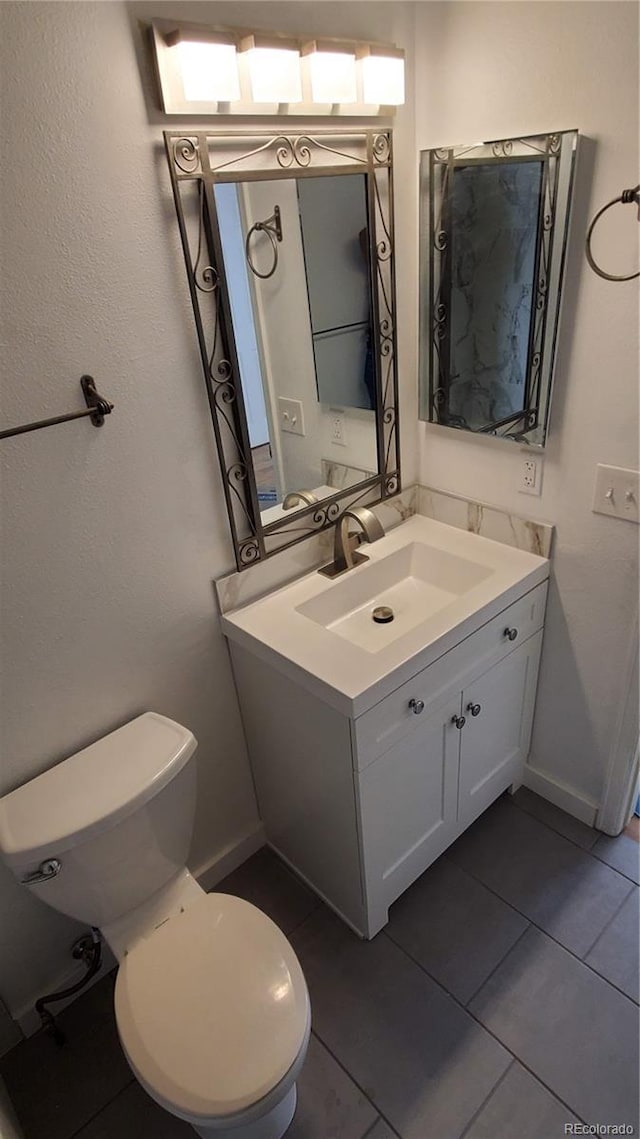 1633 18th St Unit 2, Boulder, CO 80302 - bathroom with toilet, vanity, tile patterned floors, and baseboards