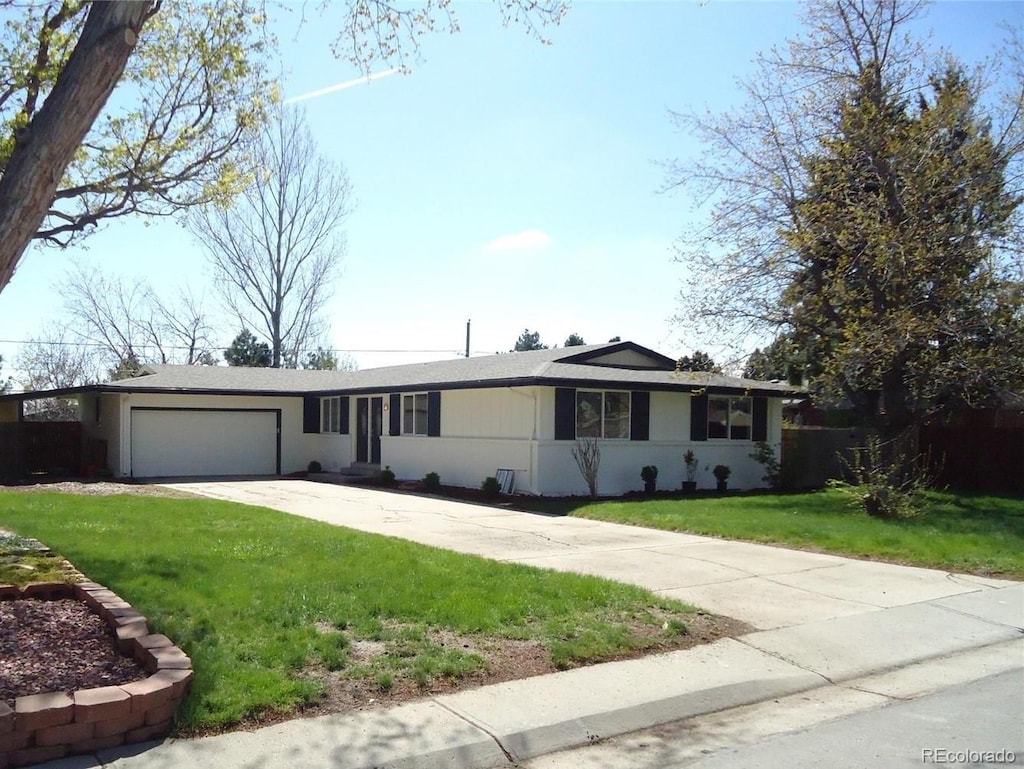 single story home with a garage and a front yard