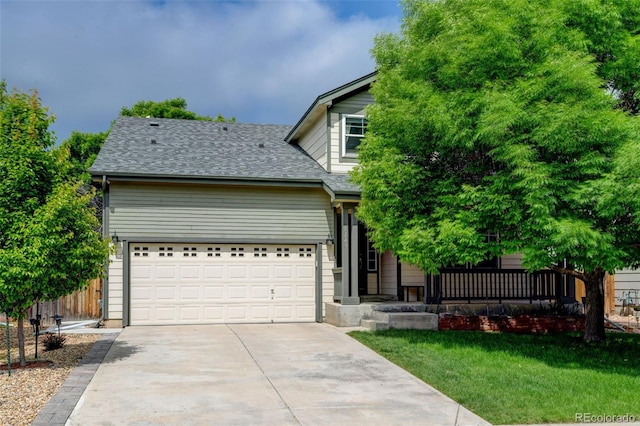 7245 Prairie Cir, Longmont, CO 80504 - obstructed view of property featuring concrete driveway, a front lawn, an attached garage, roof with shingles, and a porch