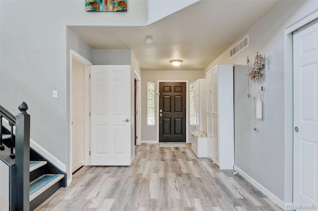7245 Prairie Cir, Longmont, CO 80504 - entryway with light wood finished floors and stairs