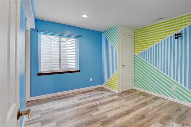 7245 Prairie Cir, Longmont, CO 80504 - spare room with wallpapered walls and wood finished floors