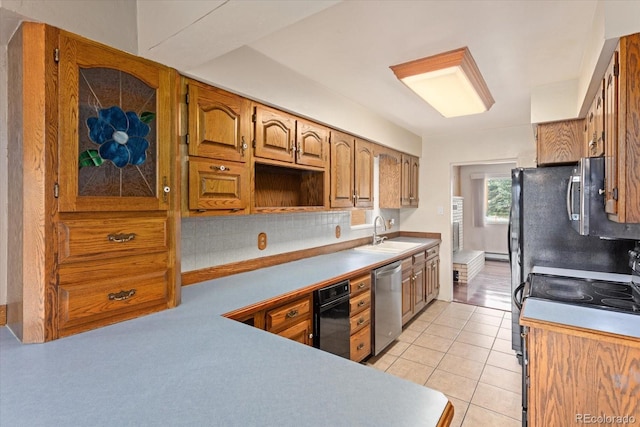 kitchen featuring backsplash, sink, stainless steel dishwasher, electric range, and light tile patterned floors