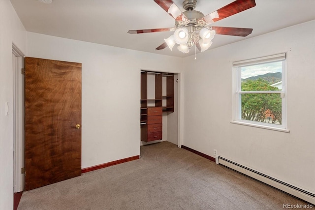 unfurnished bedroom with ceiling fan, a closet, light carpet, and a baseboard heating unit