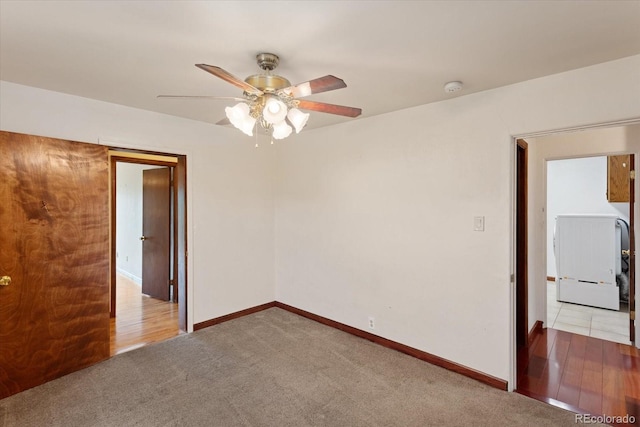 carpeted spare room featuring ceiling fan