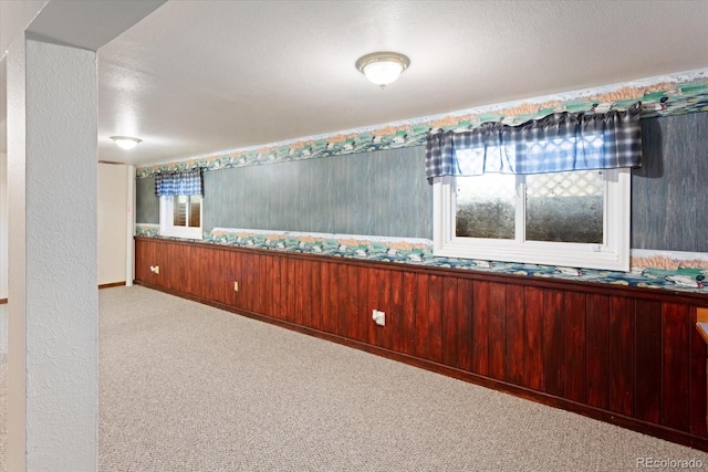 carpeted spare room with a textured ceiling