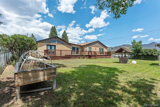 view of yard with a gazebo and a deck with mountain view