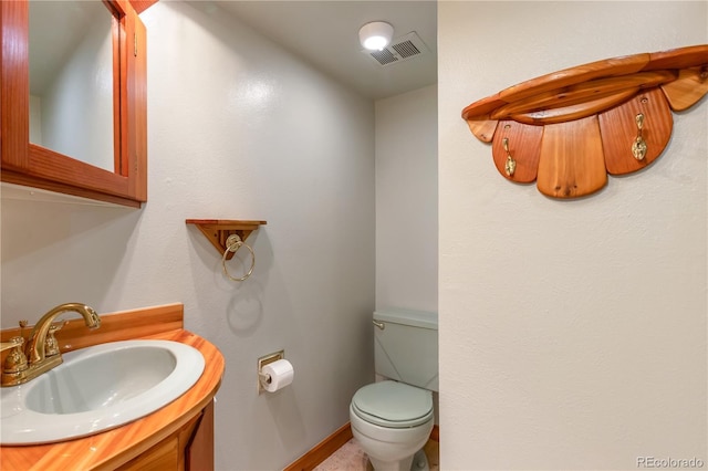 10991 E Vassar Dr, Aurora, CO 80014 - bathroom featuring toilet, vanity, and baseboards