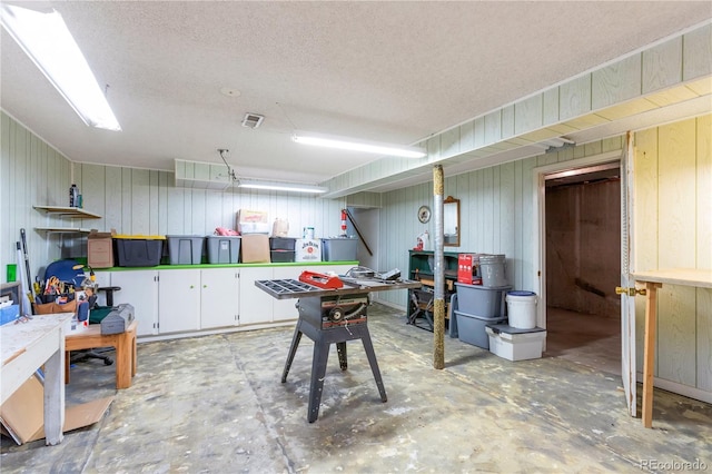 10991 E Vassar Dr, Aurora, CO 80014 - basement featuring a textured ceiling and wooden walls