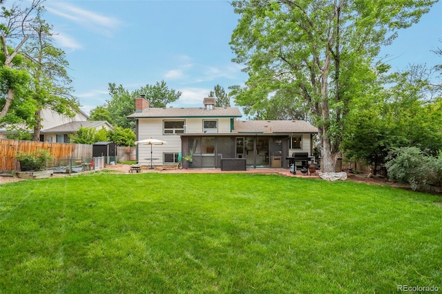 10991 E Vassar Dr, Aurora, CO 80014 - rear view of house with a sunroom and a chimney