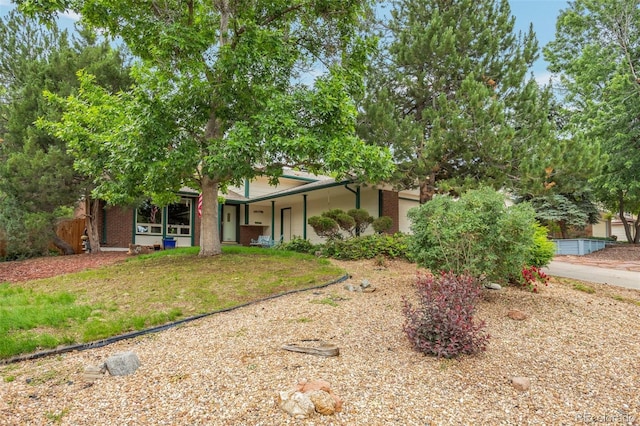 10991 E Vassar Dr, Aurora, CO 80014 - obstructed view of property with covered porch and brick siding