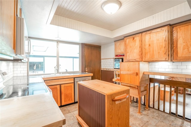 10991 E Vassar Dr, Aurora, CO 80014 - kitchen with dishwasher, butcher block counters, white microwave, a sink, and tasteful backsplash