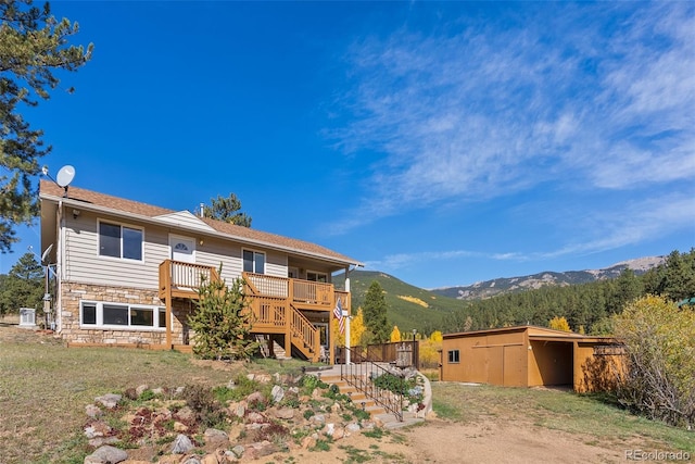 view of front facade featuring a deck with mountain view